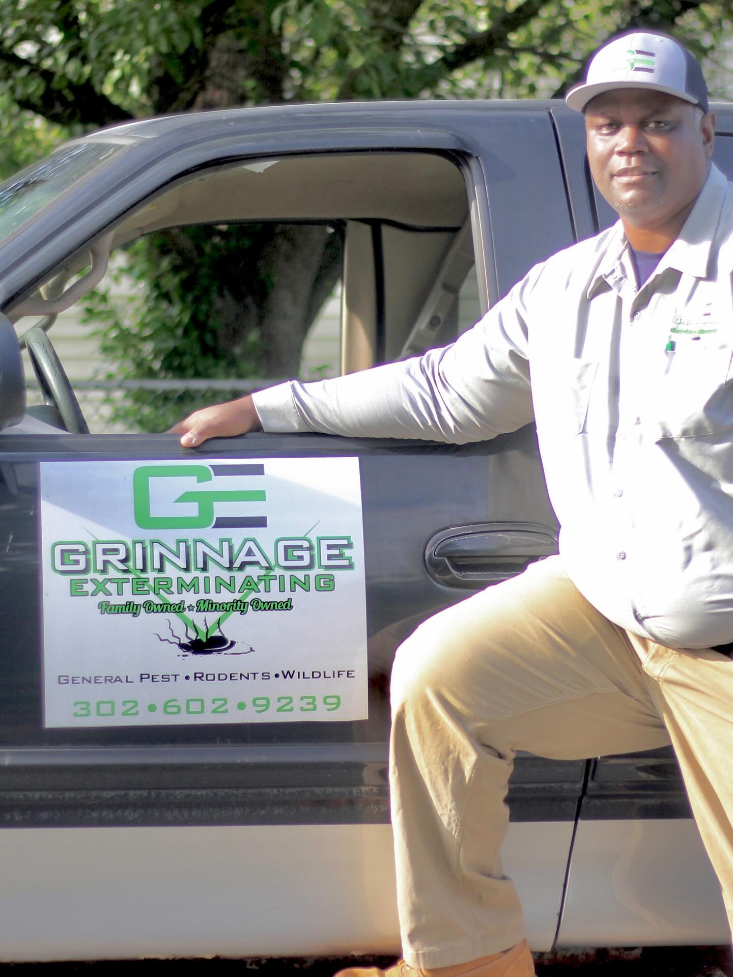 Keith Grinnage, owner of Grinnage Exterminating, beside the company truck in Delaware.